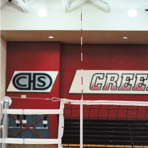 volleyball antenna, red and white, attached to a volleyball net